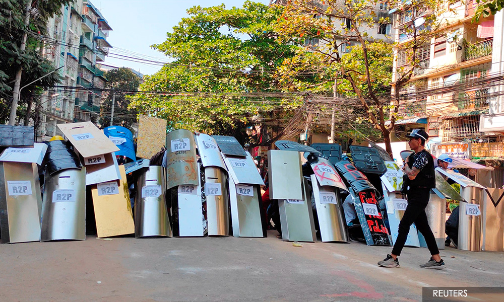 Myanmar forces make night raids after breaking up protests