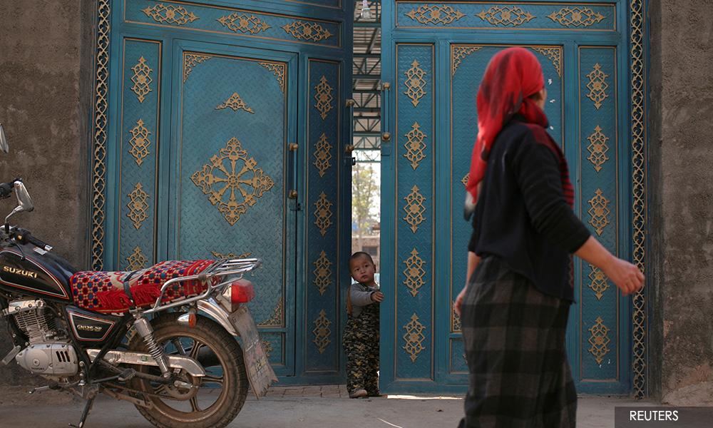 In China's new Xinjiang: patriotic tourism, riot police and minders