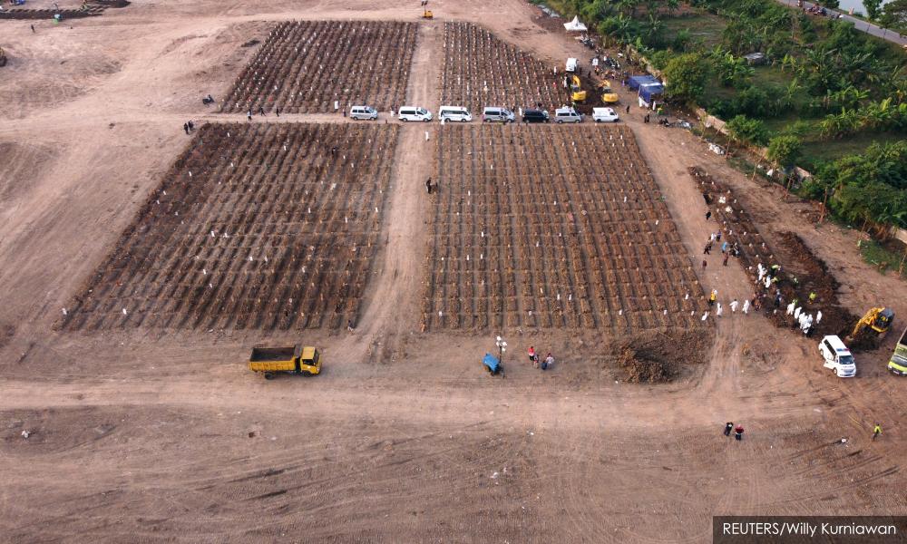 Images of expanding graves capture Indonesia's deadliest days