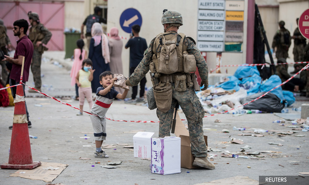 Biden says US unwavering in Afghanistan evacuations while Taliban beat back crowd at airport
